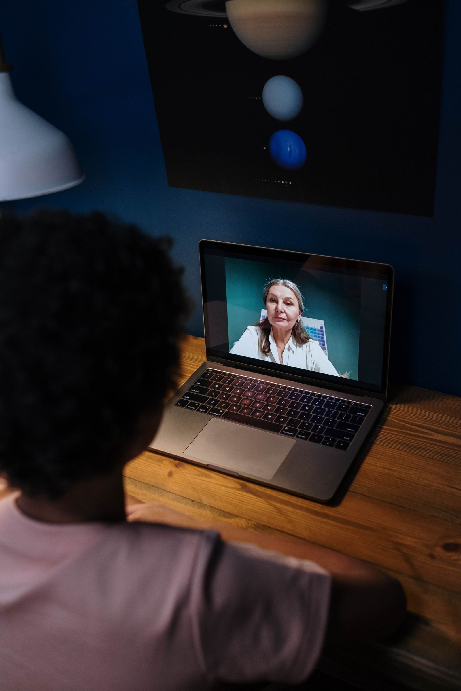 A teenager taking part in a live online lesson from home